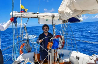 Local Galapagos Trails host at the helm of the Merak sailboat